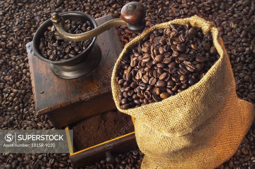 Coffee mill, coffee beans in jute bag, close-up