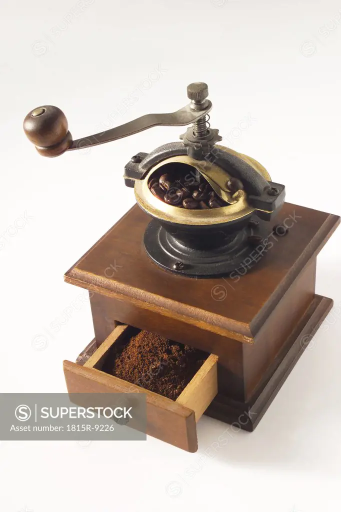 Coffee mill with coffee beans and ground coffee