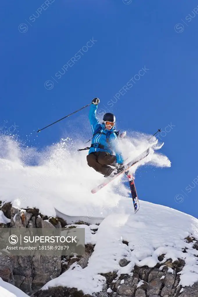Austria, Zuers, Young man doing telemark skiing on Arlberg mountain