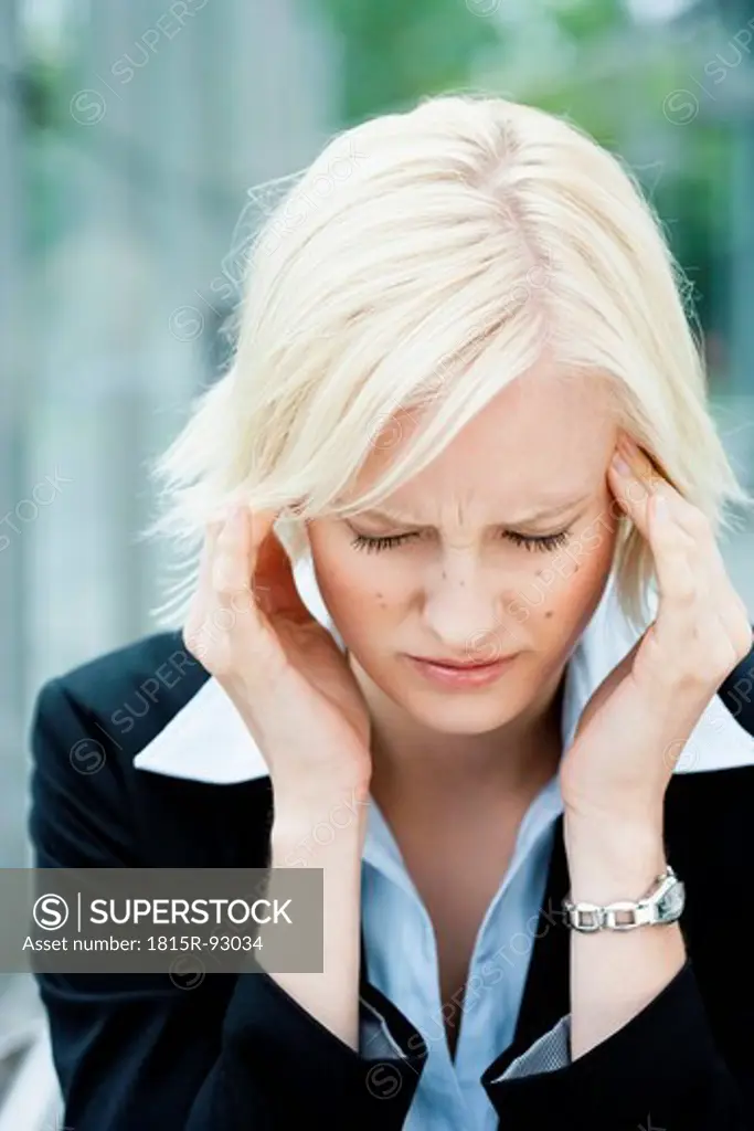 Germany, Bavaria, Munich, Young woman suffering from headache