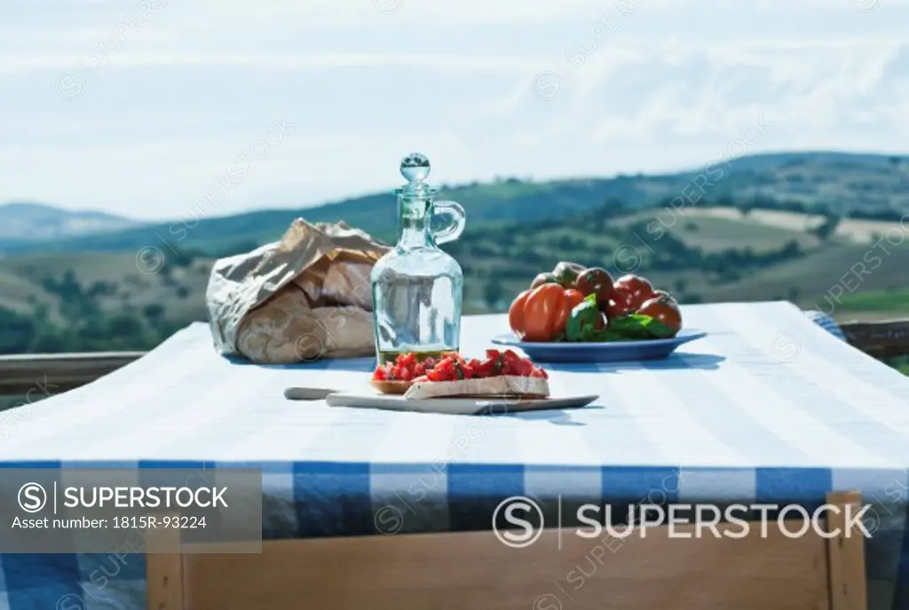Italy, Tuscany, Magliano, Bruschetta, bread, tomatoes and olive oil on table