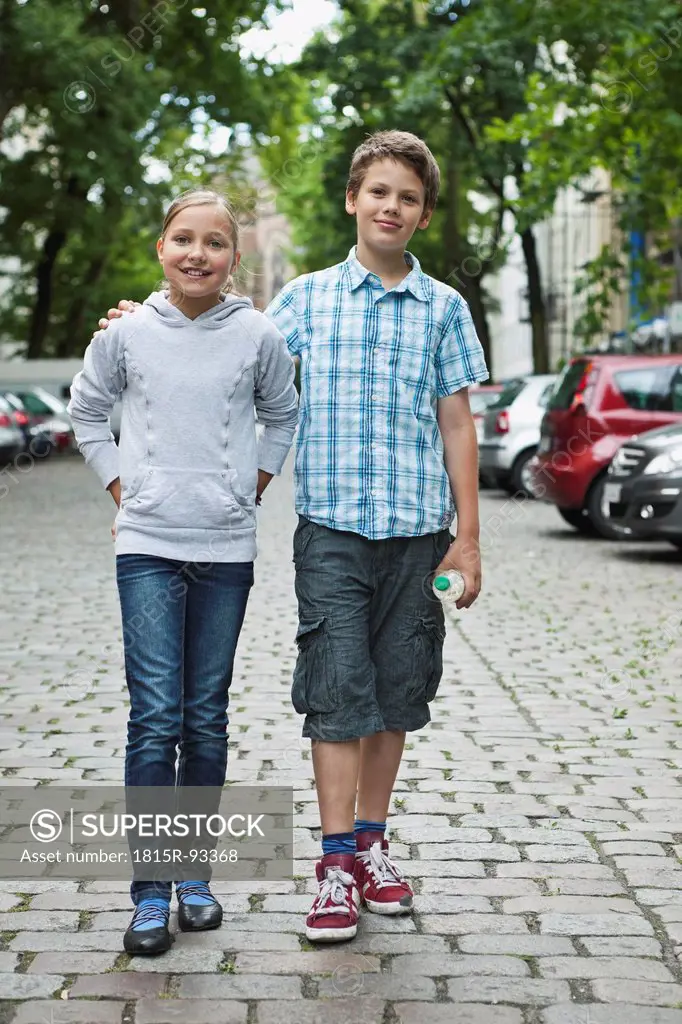 Germany, Berlin, Boy and girl walking in street as couple