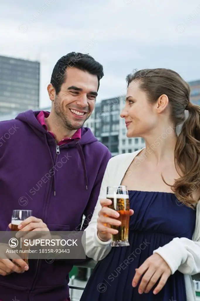 Germany, Berlin, Couple drinking beverages