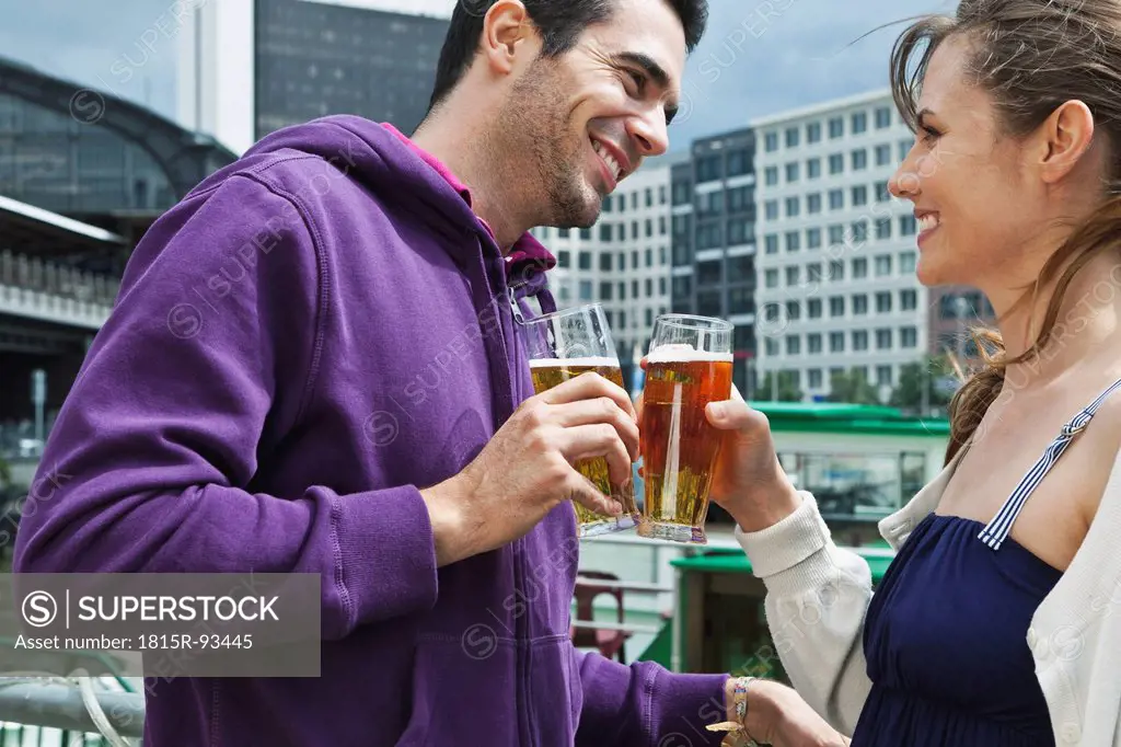 Germany, Berlin, Couple drinking beverages