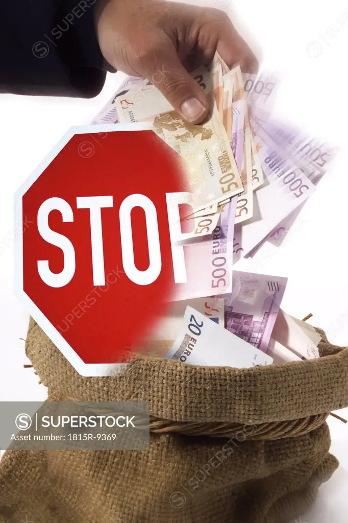 man taking money out of a sack, stop sign