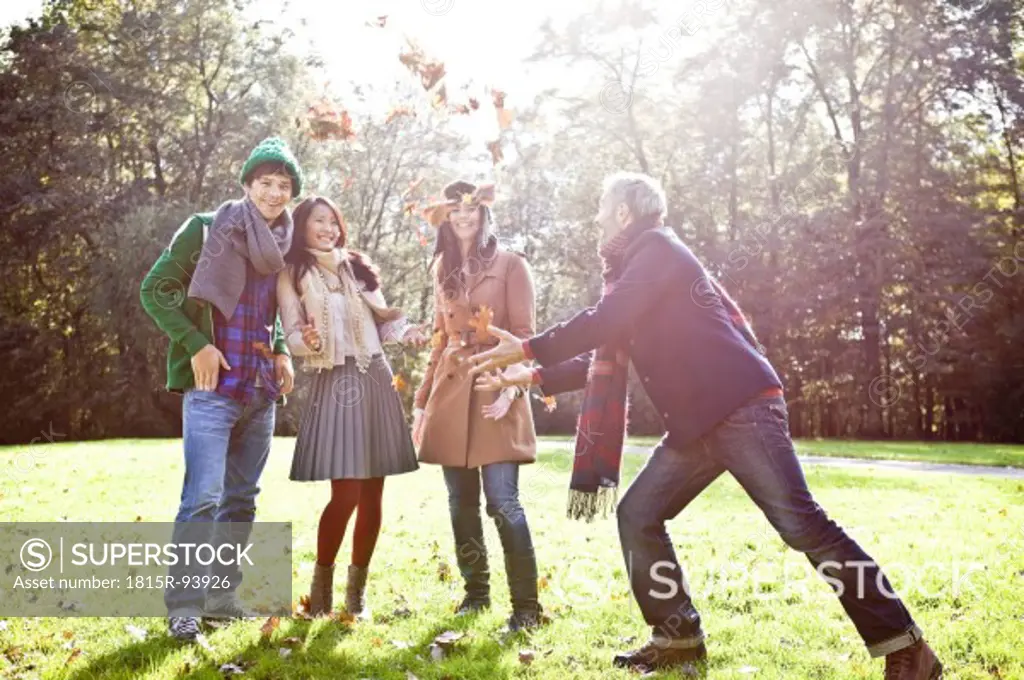Germany, Cologne, Man and woman enjoying in park, smiling