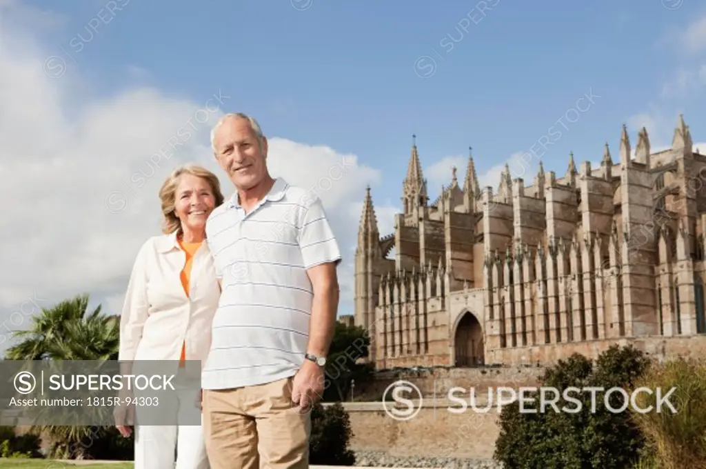 Spain, Mallorca, Palma, Senior couple smiling with Cathedral Santa Maria, portrait