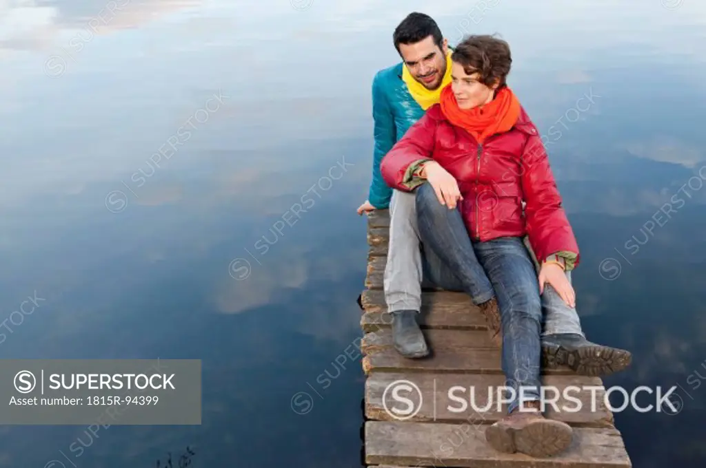 Germany, Berlin, Wandlitz, Couple sitting on pier