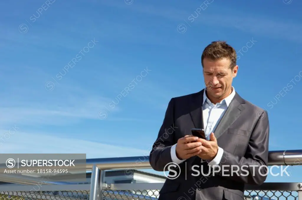 Germany, Bavaria, Munich, Businessman using cell phone