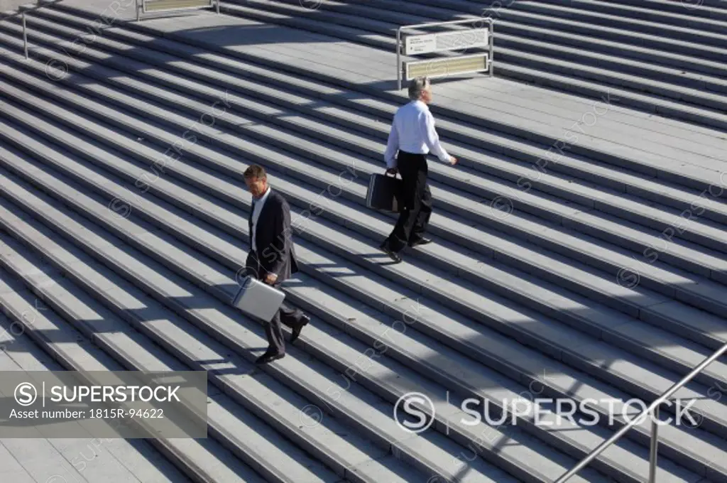 Germany, Bavaria, Munich, Engineers walking on stairs with briefcase