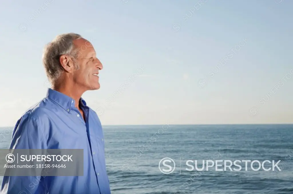 Spain, Mallorca, Senior man standing at sea shore