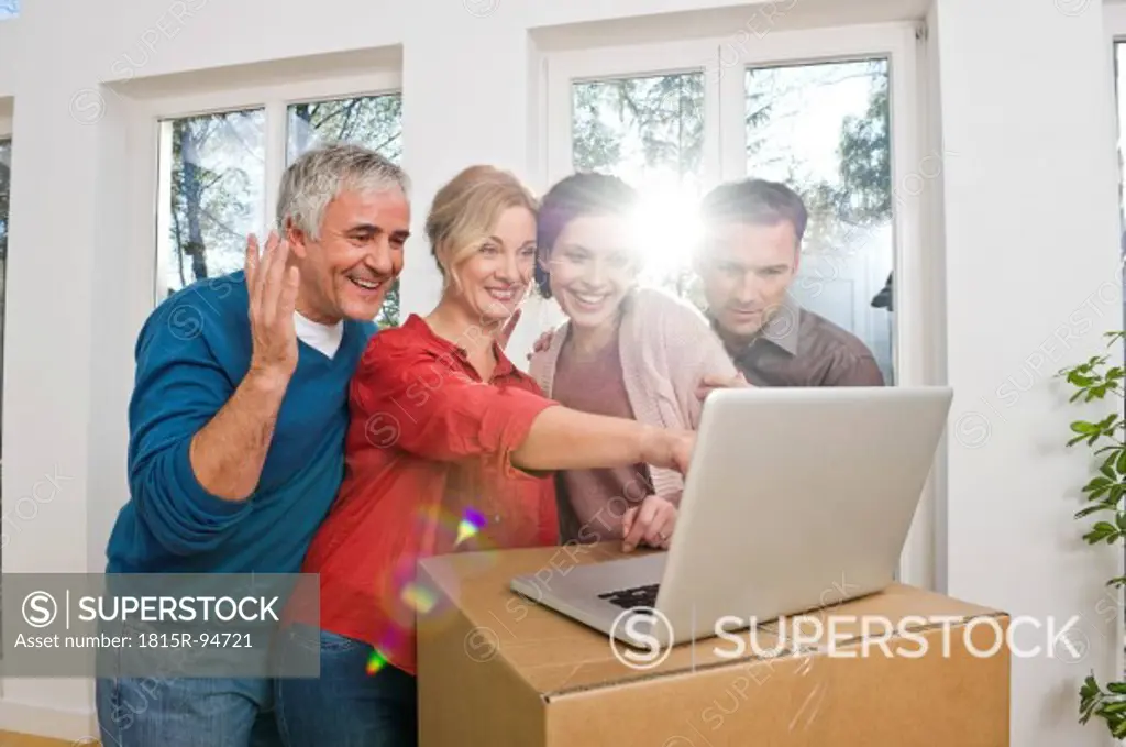 Germany, Bavaria, Grobenzell, Man and woman using laptop, smiling