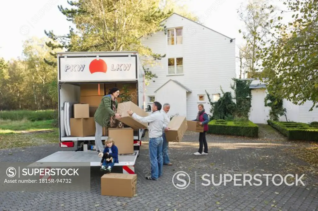 Germany, Bavaria, Grobenzell, Family loading boxes into truck for moving house