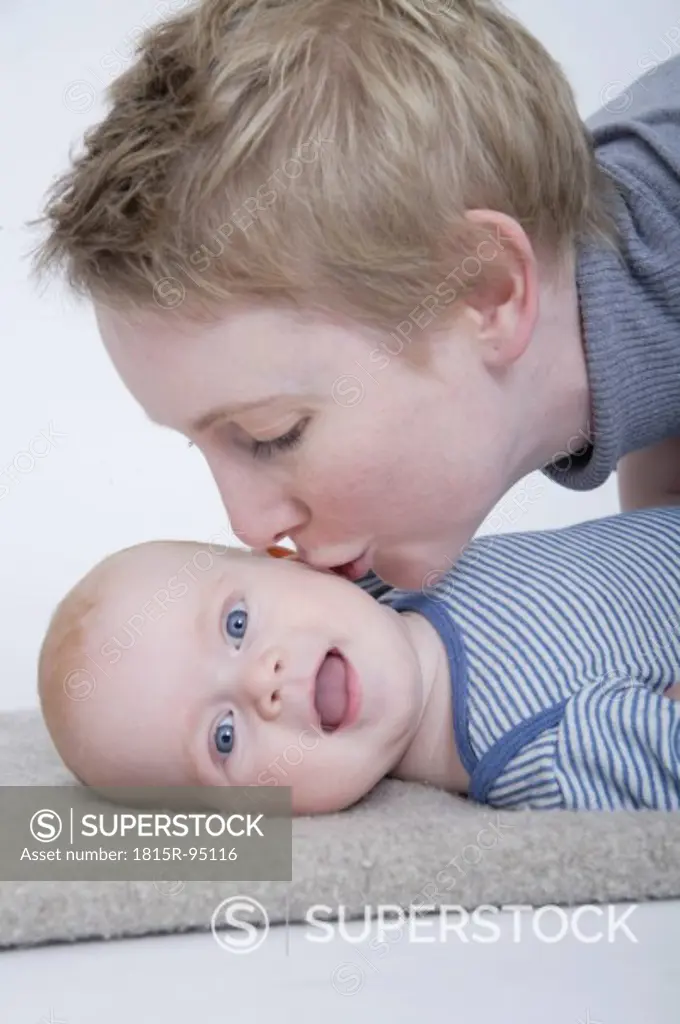 Mother kissing baby boy, close up