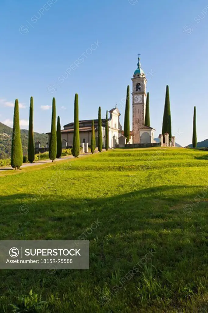 Switzerland, Ticino, Montagnola, View of church with cypress