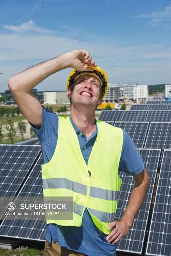 Germany, Munich, Technician in solar plant, smiling