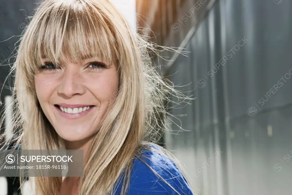 Germany, Cologne, Young woman smiling, portrait