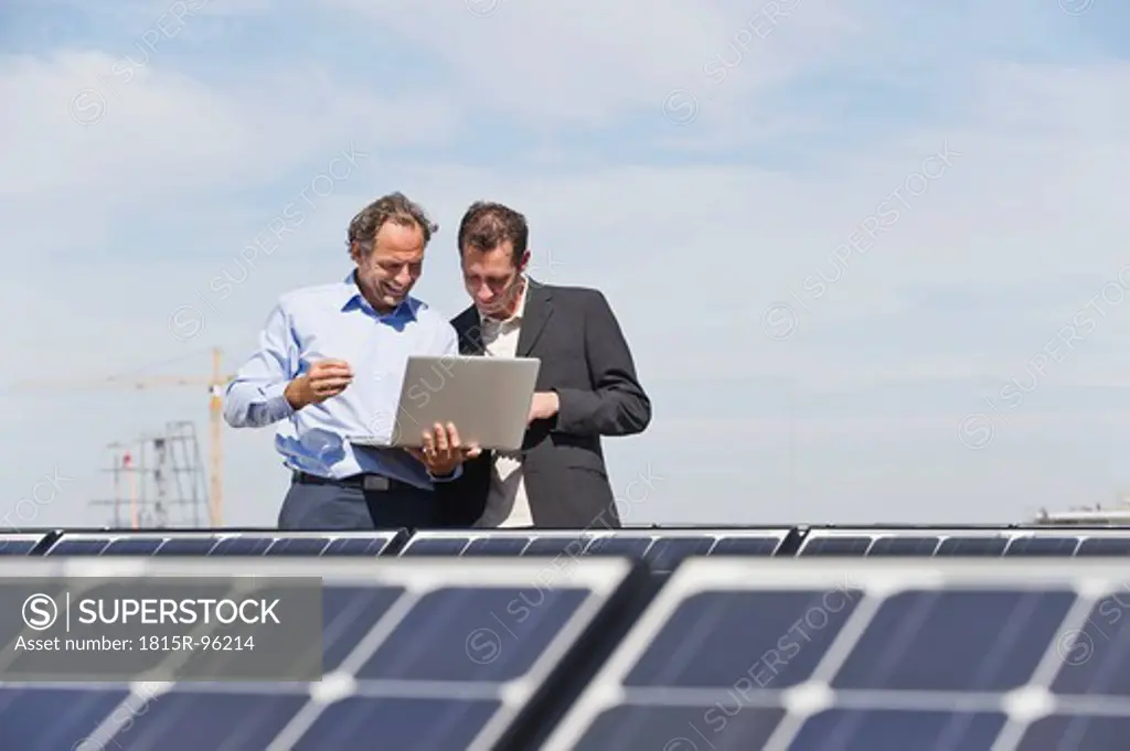 Germany, Munich, Engineer with man in solar plant