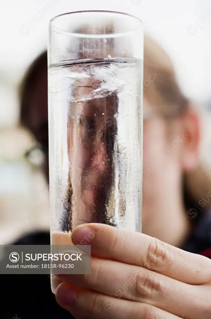 Greece, Ionian Islands, Ithaca, Woman face reflecting in glass of water