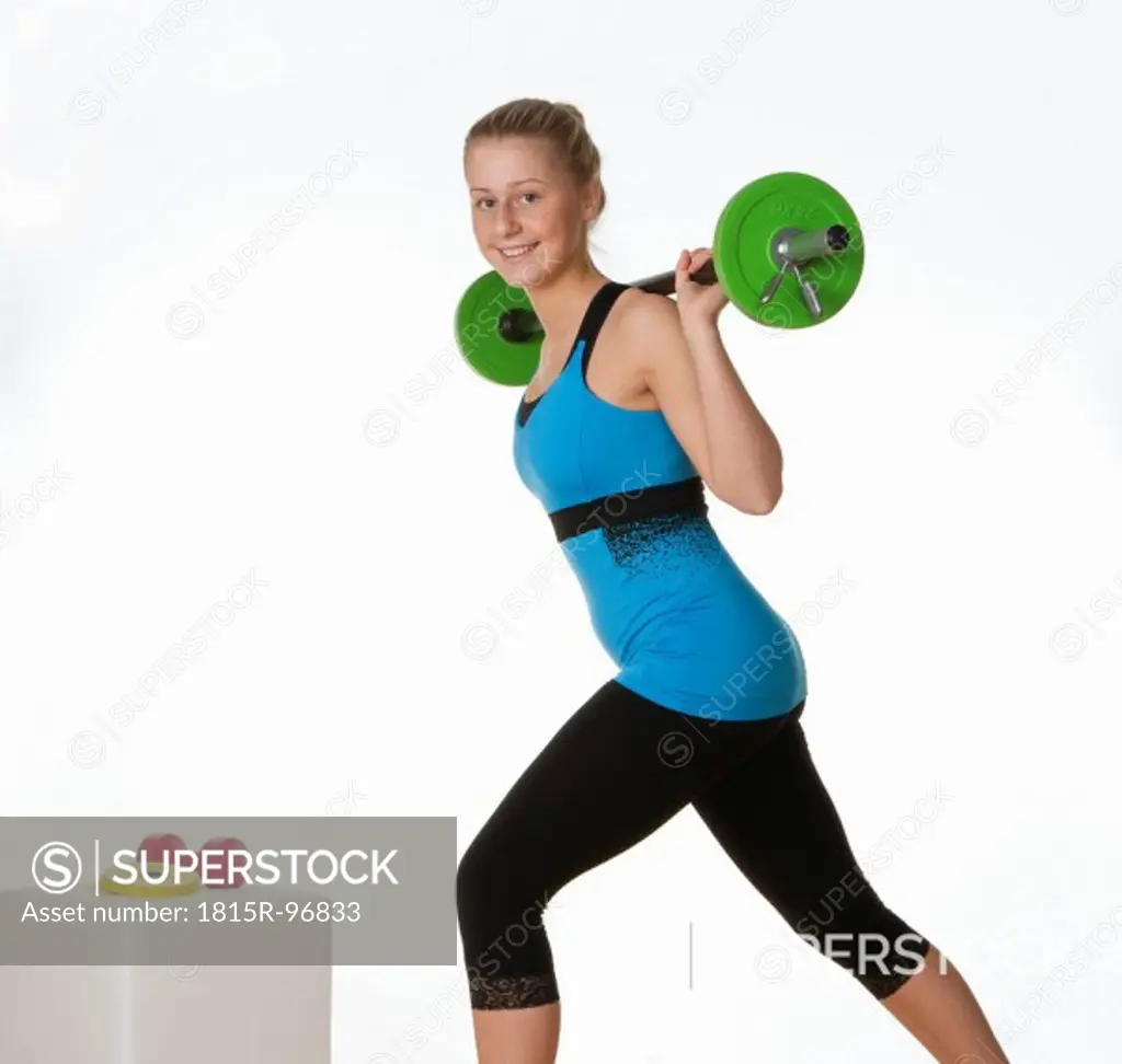 Teenage girl exercising in gym, portrait