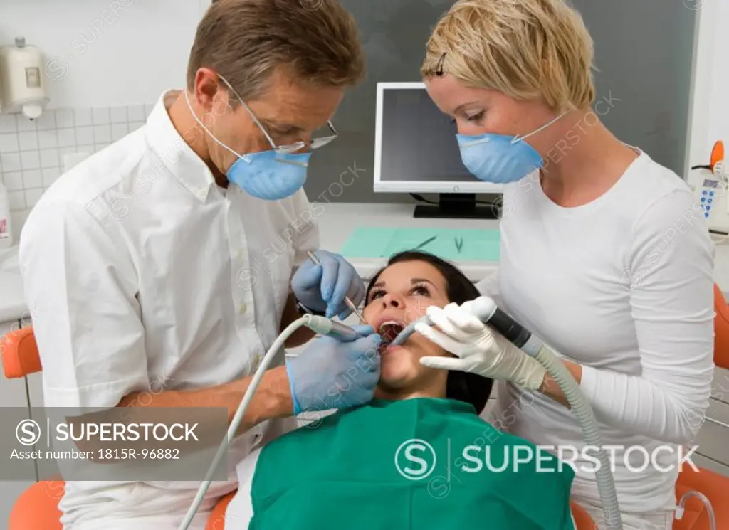 Austria, Dentist and nurse examining patient