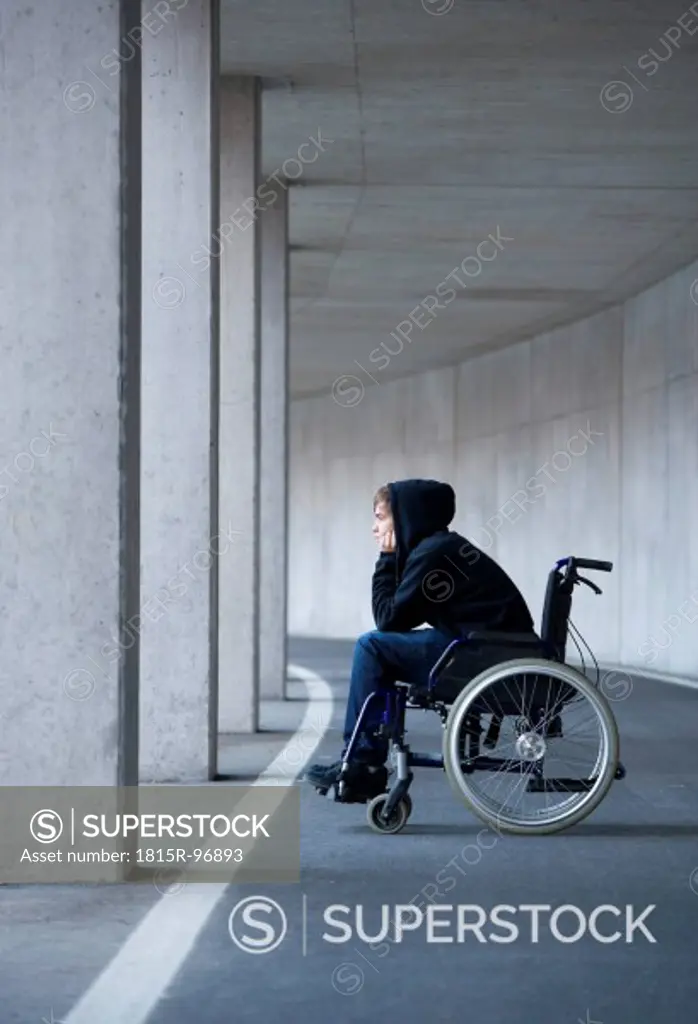 Austria, Mondsee, Young man sitting on wheelchair at subway