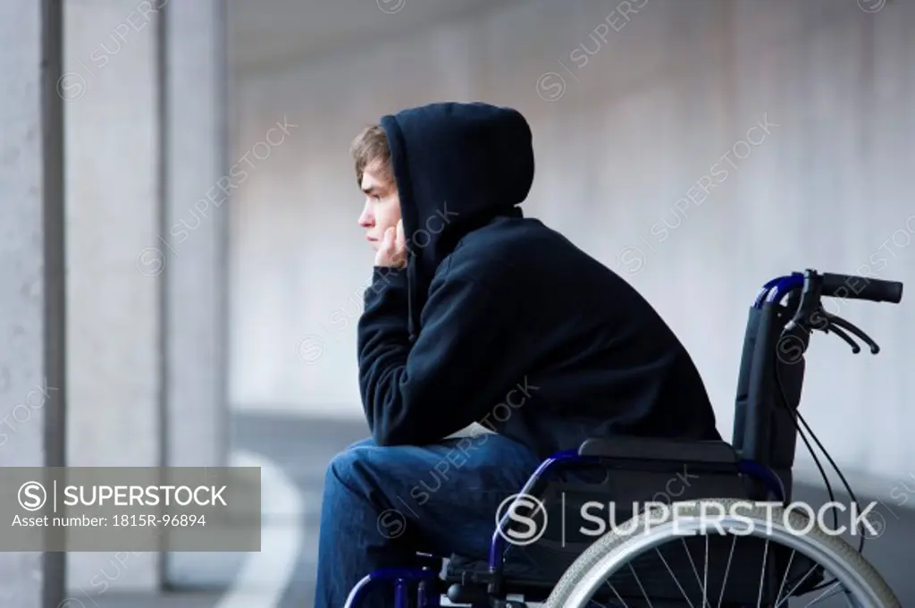 Austria, Mondsee, Young man sitting on wheelchair at subway