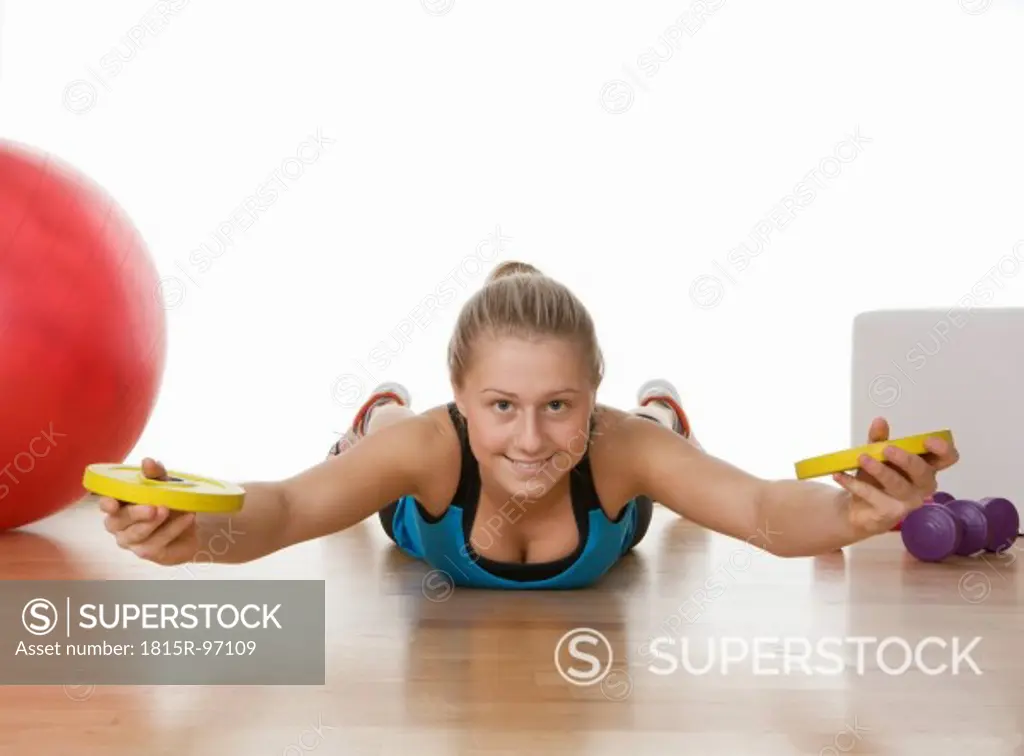 Europe, Teenage girl exercising in gym, portrait
