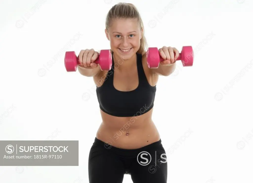 Teenage girl exercising in gym, portrait