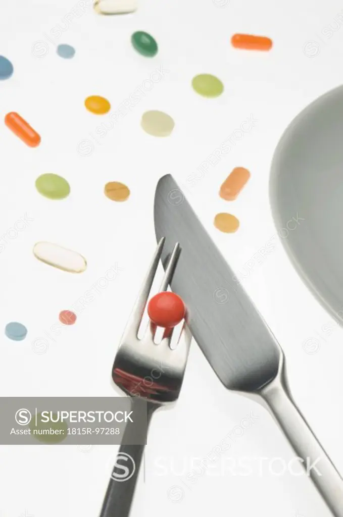 Variety of medicines with cutlery, close up