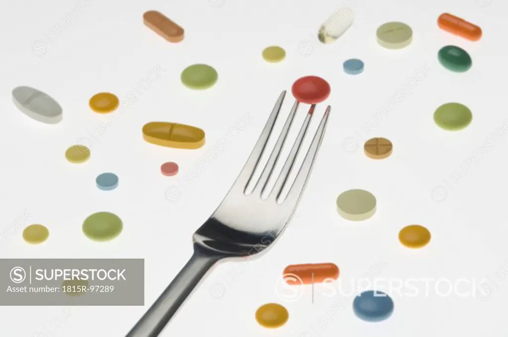 Variety of medicines with fork, close up