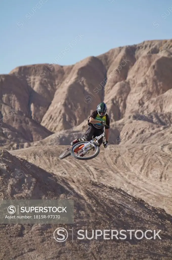 USA, California, Mountain biker jumping in air
