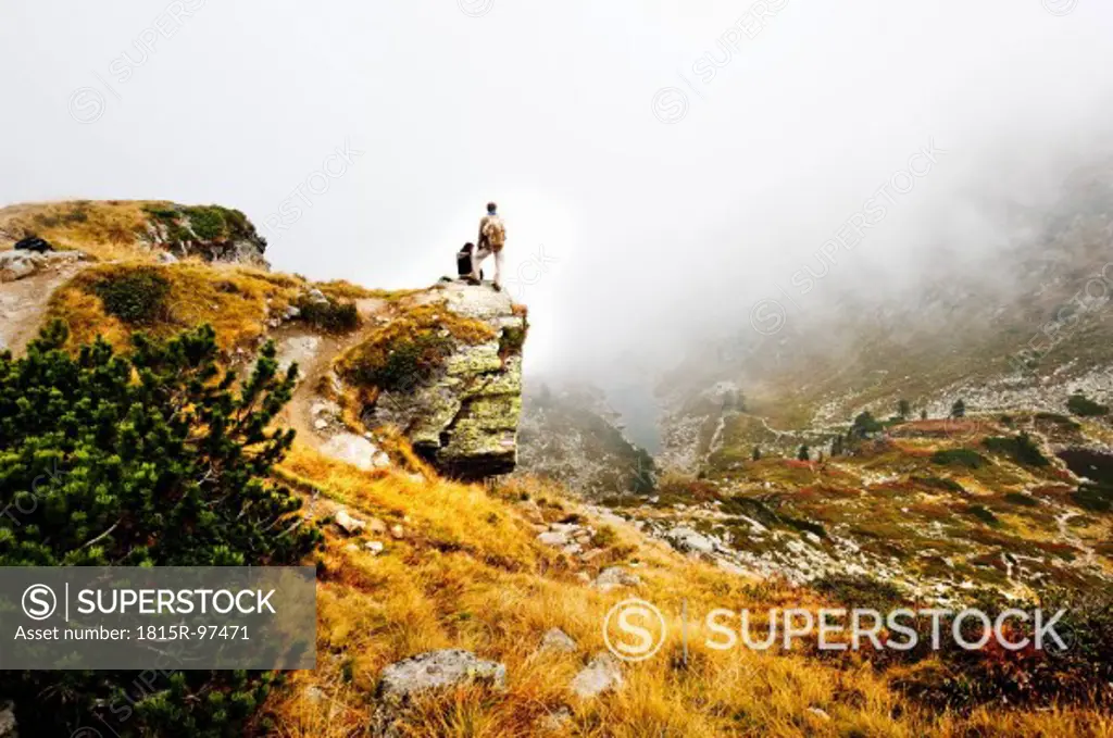 Austria, Styria, Man and woman standing on rock, watching Lake Obersee