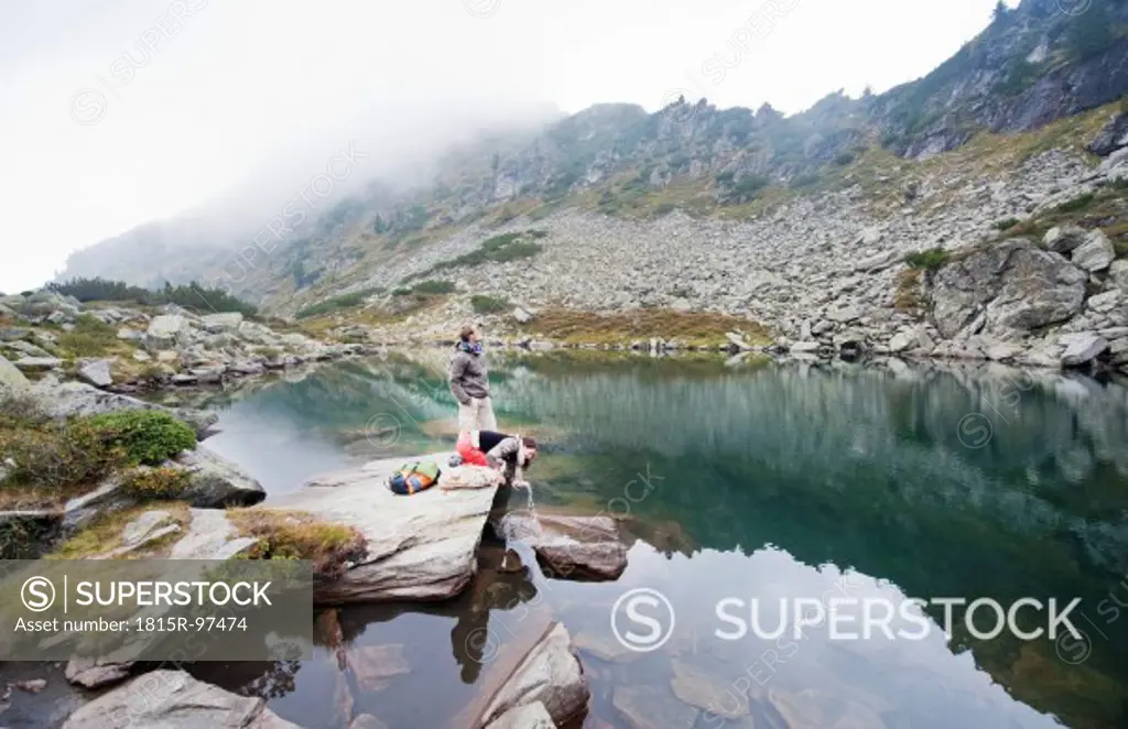 Austria, Styria, Man and woman having rest at Lake Obersee