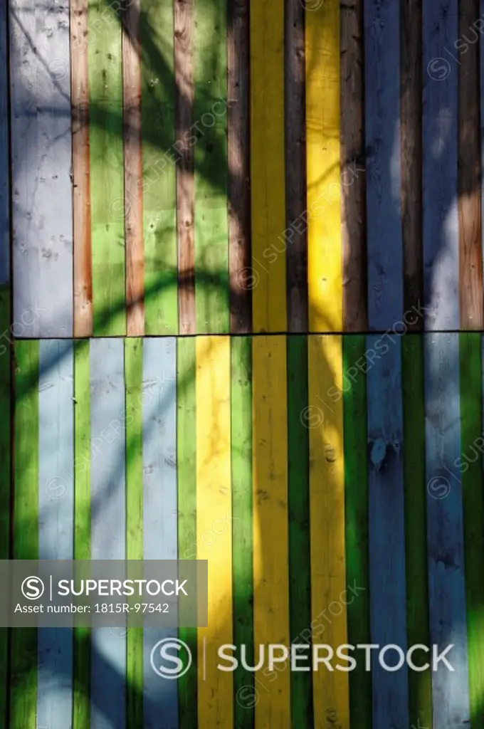 Germany, Berlin, Shadow on coloured wooden wall