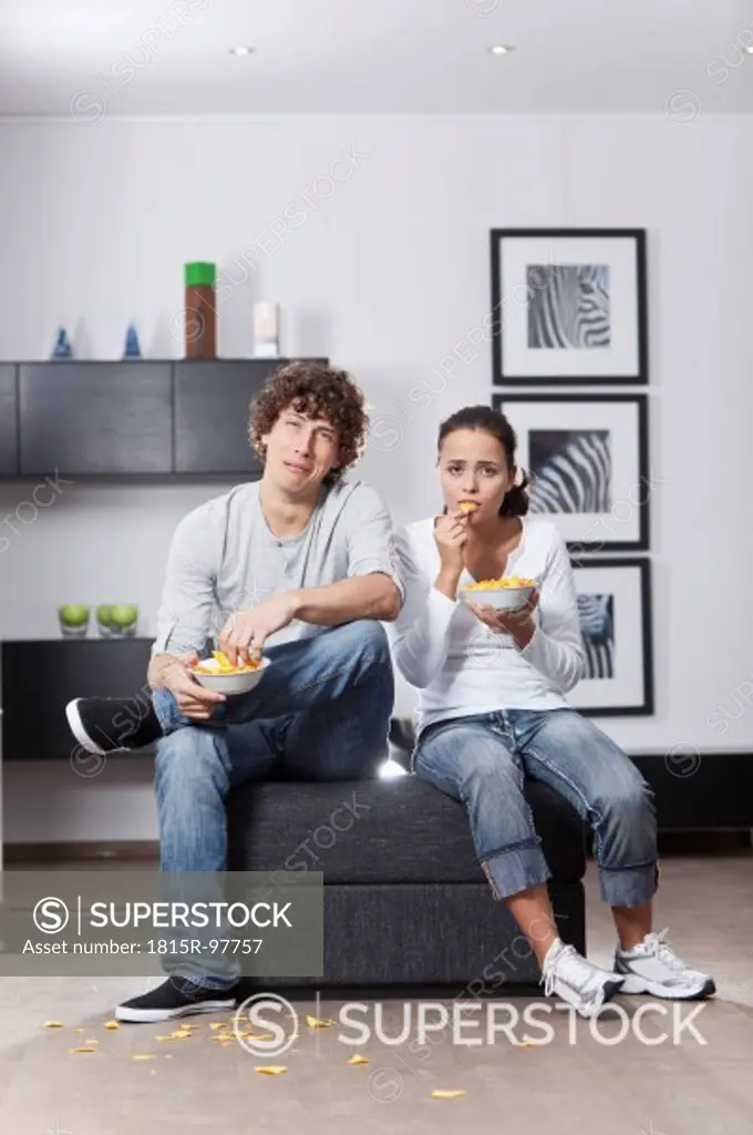 Germany, Bavaria, Young couple watching TV