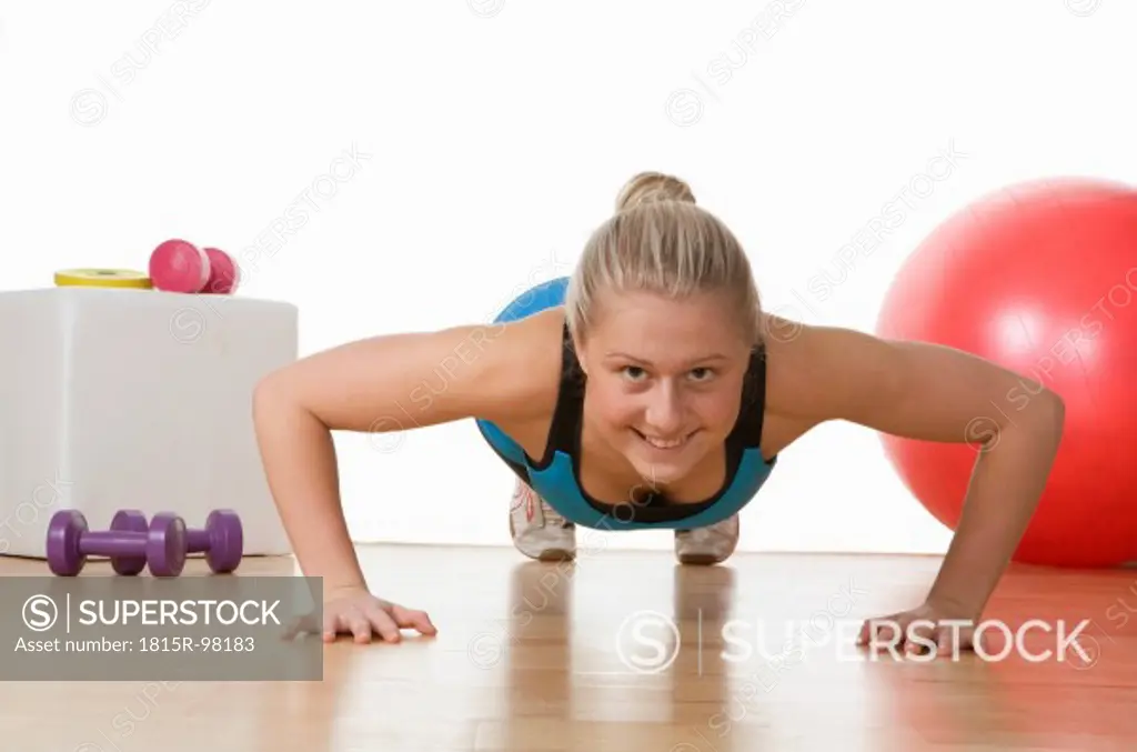 Europe, Austria, Teenage girl exercising in gym, portrait