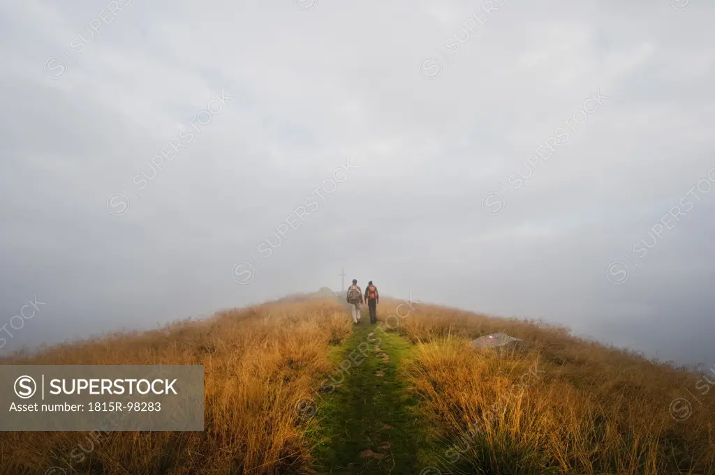 Austria, Styria, Man and woman walking on way to summit at Reiteralm