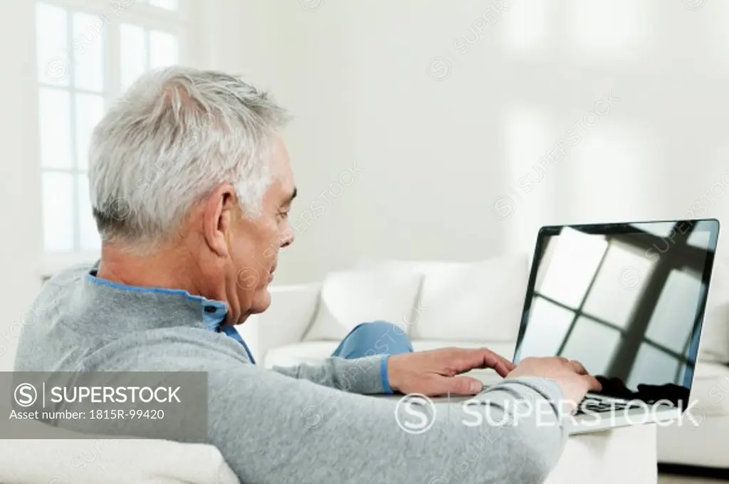 Germany, Berlin, Senior man using laptop