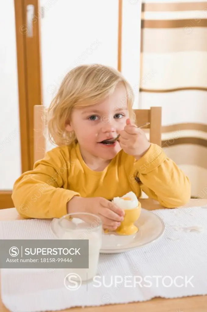 Girl eating boiled egg in breakfast, eating egg
