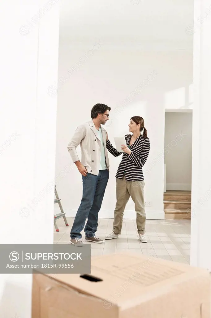 Germany, Berlin, Mature couple inspecting new house