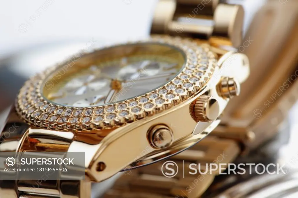 Golden wrist watch with jewels, close up