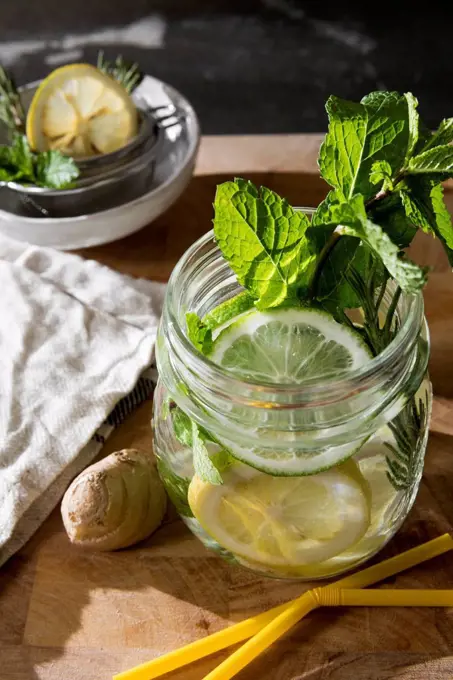 Glass of detox water with mint, ginger, rosmary and limes