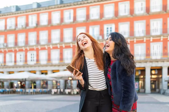 Spain, Madrid, Plaza Mayor, two best friends having fun together in the city