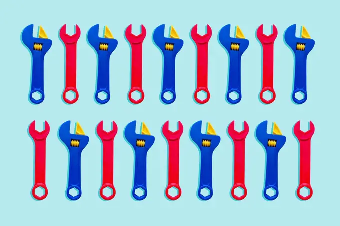 Illustration of two rows of red and blue toy wrenches