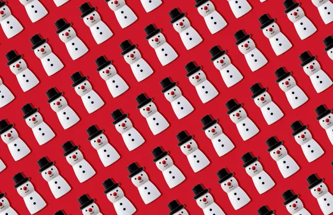 Christmas snowmen pattern against red background