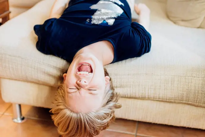 Screaming boy lying on couch