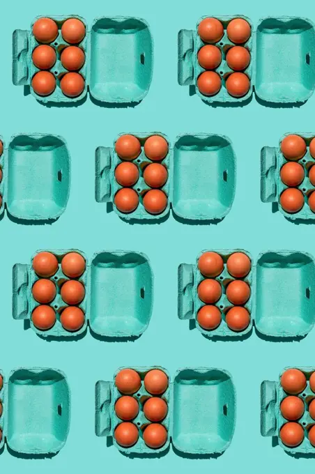 Pattern of chicken eggs in turquoise colored cartons