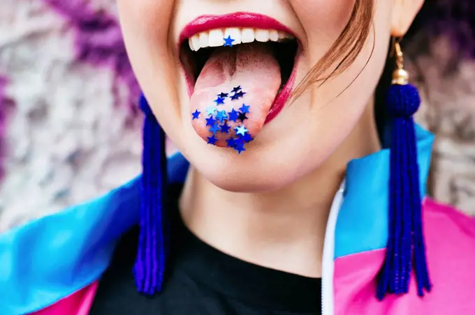 1980s retro-styled woman with stars on tongue