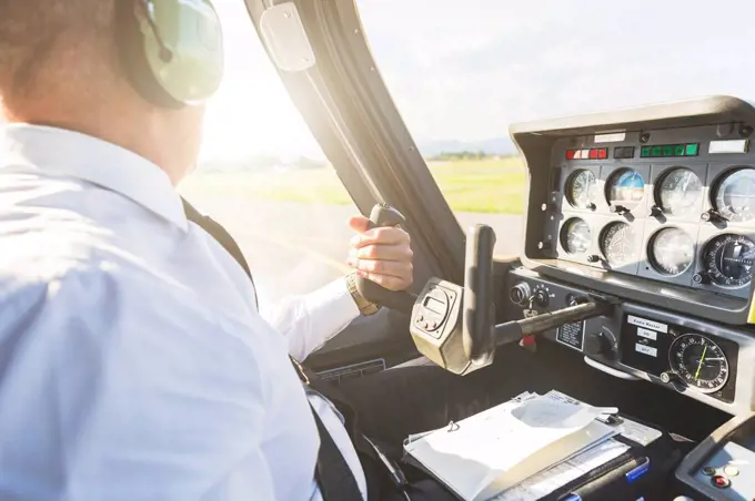Pilot flying in sports plane, using control wheel